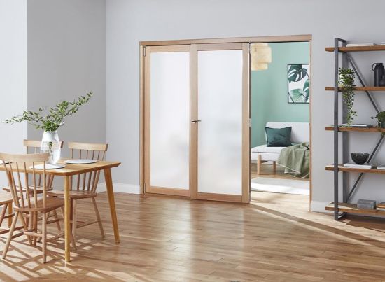 Access door open - Finesse Oak 2.4m (approx 8ft) Frosted Internal Bifold Doors - Trackless