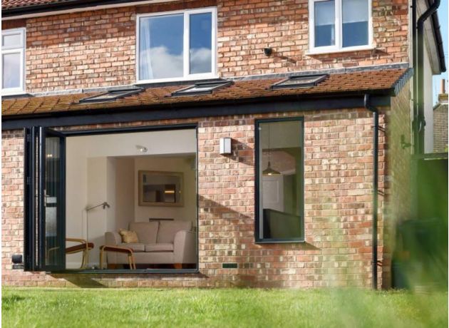 Open outside view custom grey aluminium bifold doors - Status range