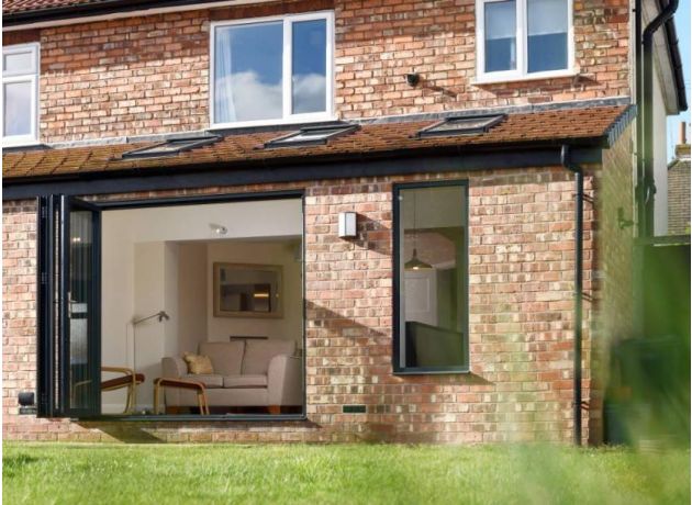 Open outside view custom grey aluminium bifold doors - Status range