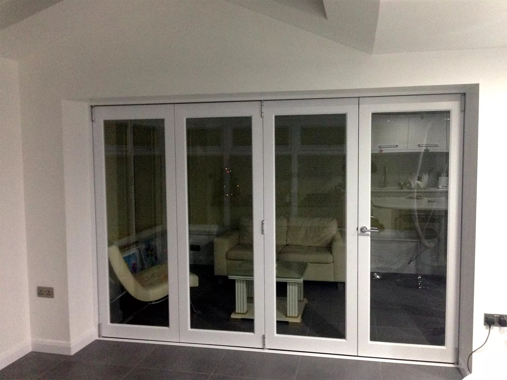 Finesse internal bifold doors open between conservatory and kitchen diner