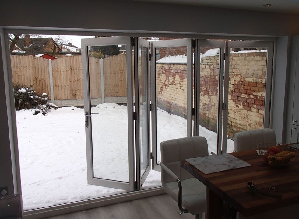 Master White 3.6M Bifold door opening to the garden