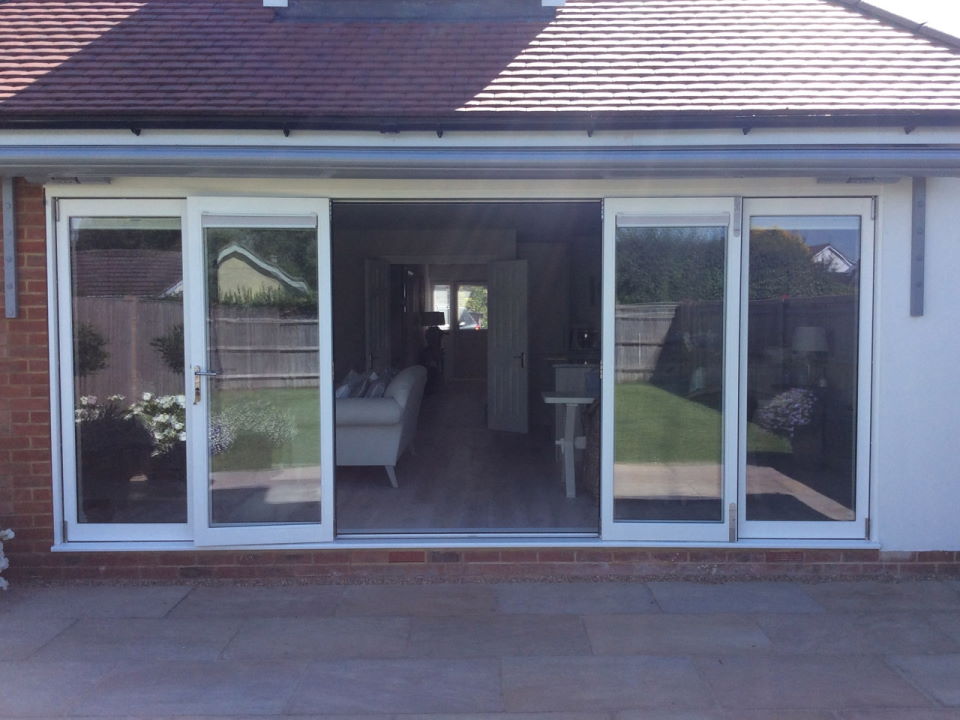 Partially open outside view Master Timber 4.8M Bifold Doors with Blinds