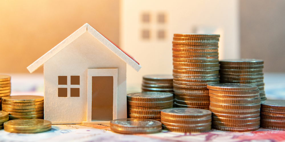 Coins next to a house