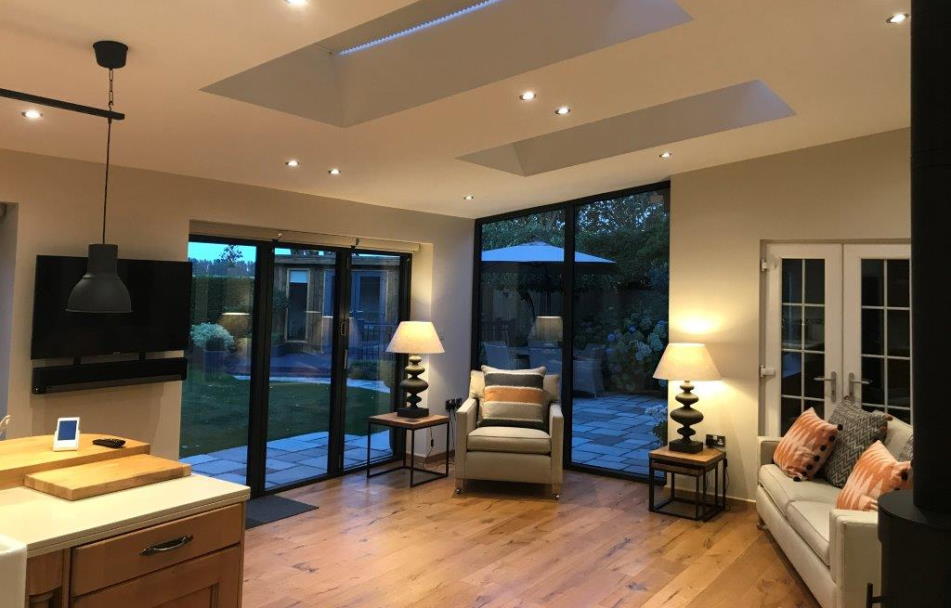 Inside view of aluminium bifold doors and bespoke windows