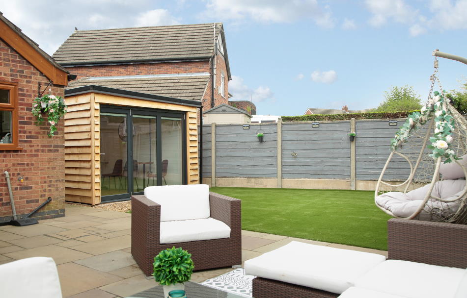 Open Supreme 3.6M White aluminium Bifold doors shows garden view