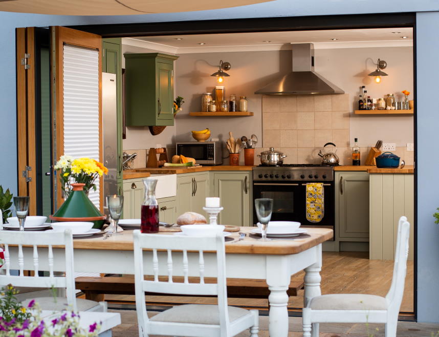 Outside open Ultra 2.7M grey bifold doors with a view into the kitchen