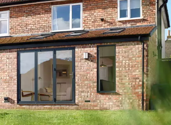 Anthracite aluminium bifold doors on a 1930s house extension