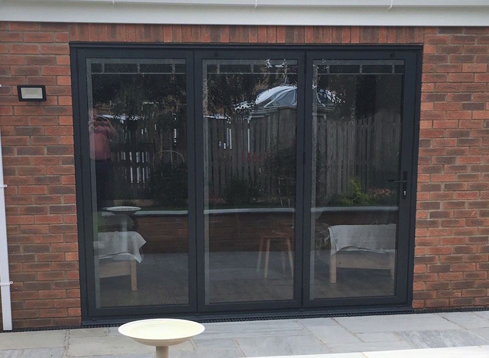 Bespoke outside view of a closed Status Aluminium Bifold doors