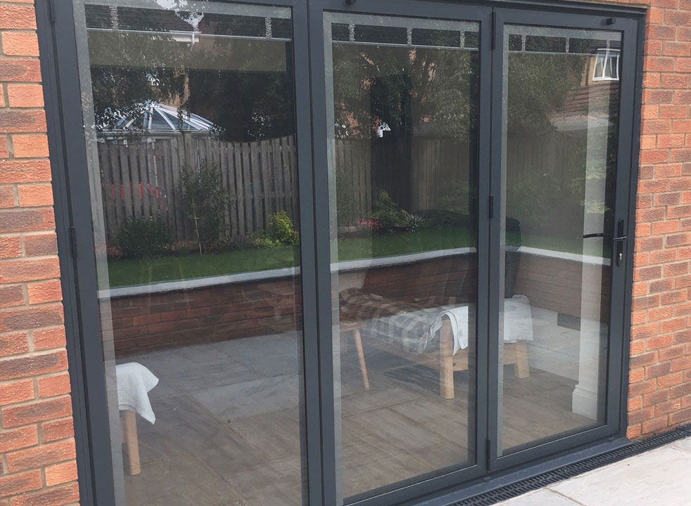 Bespoke outside side view of a closed Status Aluminium Bifold doors