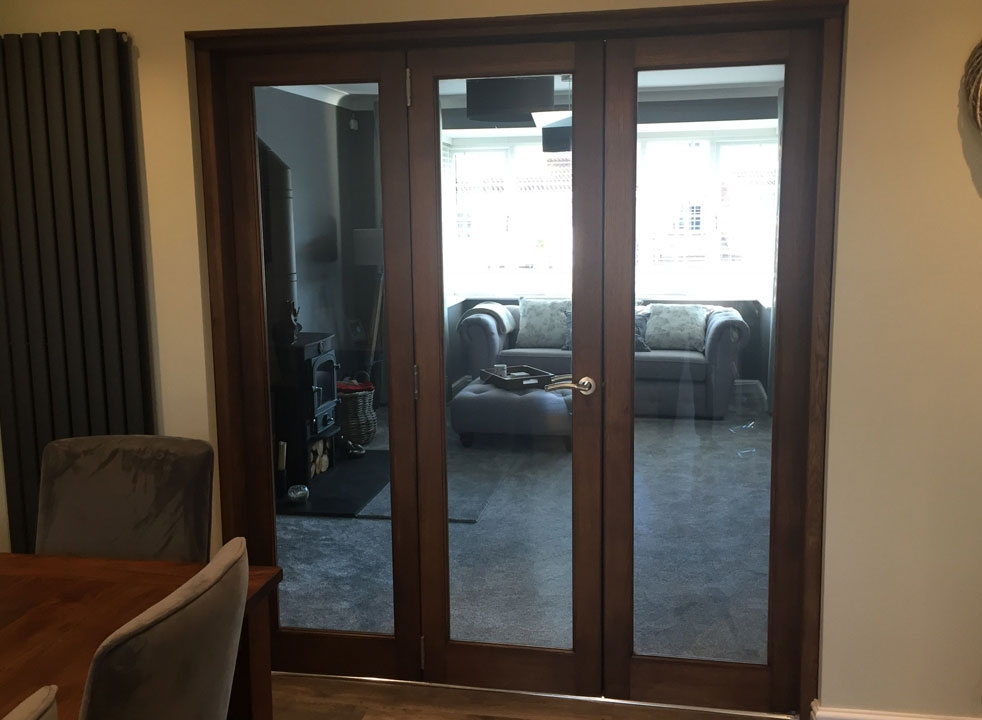 Dark stained Closed Inspire Internal Bifold doors from the dining room