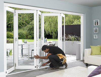 Man installing mag kit to 12ft master white external bifolding door set