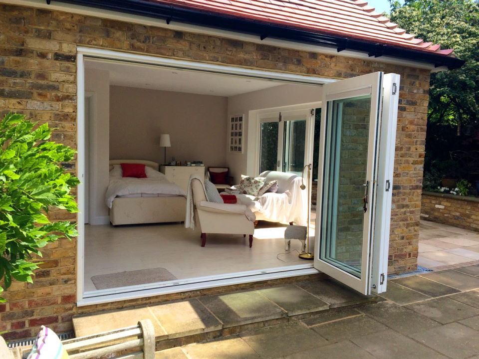 Open 9ft bifold doors looking into the bedroom-cum-lounge