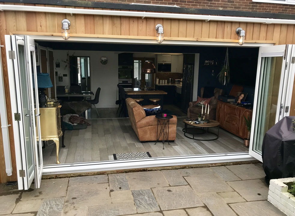 Master White 4.2M timber bifold doors open from the outside